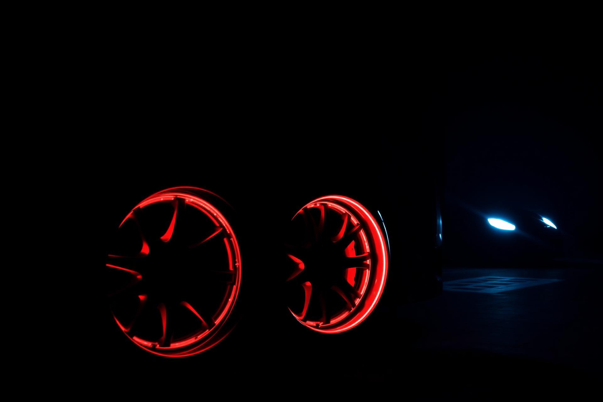 Custom wheels glowing in dark garage